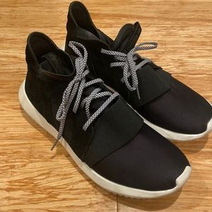 Adidas tubular black shoes.